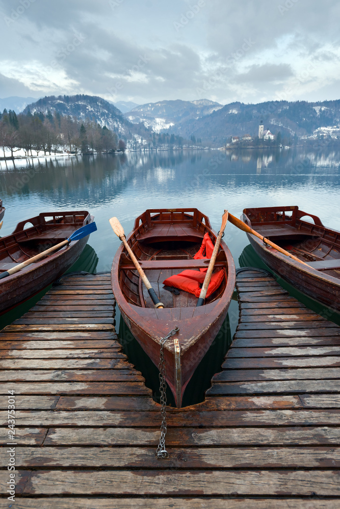 Boat at wooden pier on mountain lake, springtime