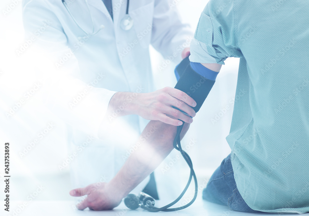 doctor and patient measuring blood pressure