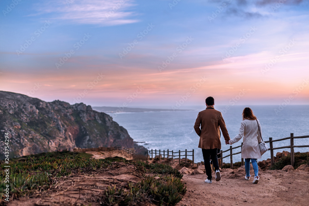 Fototapeta premium the couple in love hold hands and walk back to the camera on the