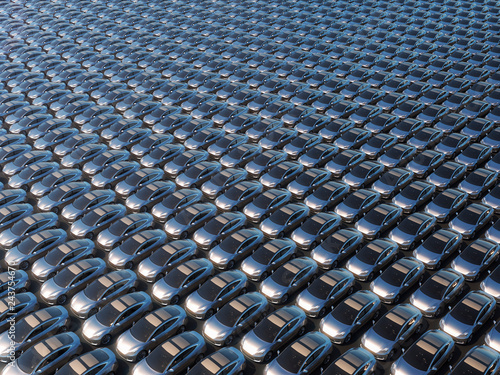 Electric cars waiting to be shipped aerial perspective view of big parking lot 3d illustration