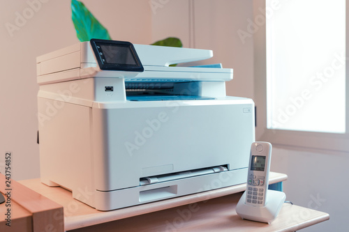 White Multi function color laser printer and wireless phone terminal. Office devices. WiFi laser printer.