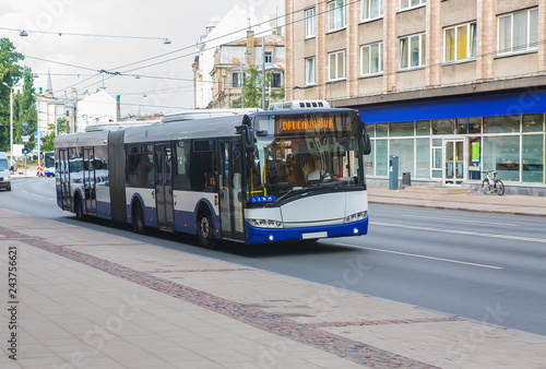 bus moves along the city street