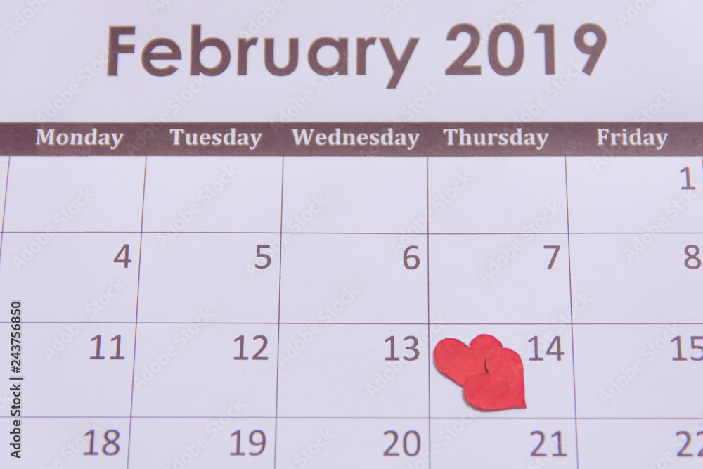 Valentines day greeting card. Red hearts paper on Calendar page February 14 with copy space Valentines day greeting card. Red hearts paper on Calendar page February 14 with copy space
