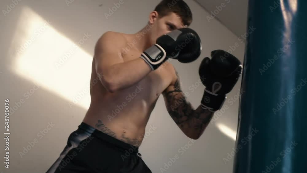 Strong caucasian man boxing using punch sake Strong caucasian man boxing using punch sake