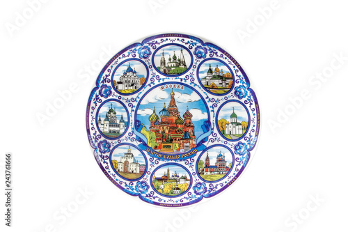 ceramic souvenir toy in the form of plate with color painting on isolated white background reflecting the national Russian culture with the inscription in Russian  The Golden ring of Russia Moscow