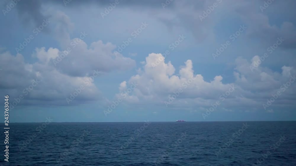 Seascape with a cloudy sky and merchant ship. Time laps. Seascape with a cloudy sky and merchant ship. Time laps.