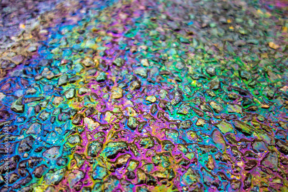 Fototapeta premium Rainbow Liquid Petrol Pollution Leak on Asphalt Road