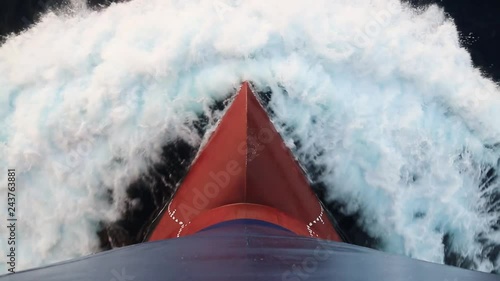 Red bow of the blue color merchant ship underway.