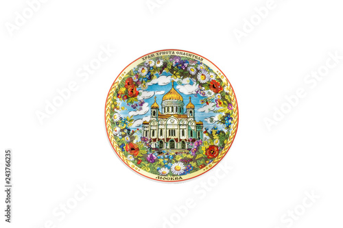 ceramic souvenir toy in the form of plate with color painting on isolated white background reflecting the national Russian culture with the inscription in Russian: Cathedral of Christ Savior of Moscow