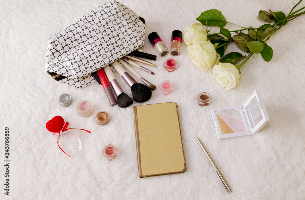 notebook and cosmetics, handbag and cosmetic brushes notebook and cosmetics, handbag and cosmetic brushes