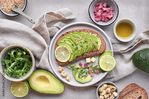 Green salad and avocado sandwich  top view on grey stone background