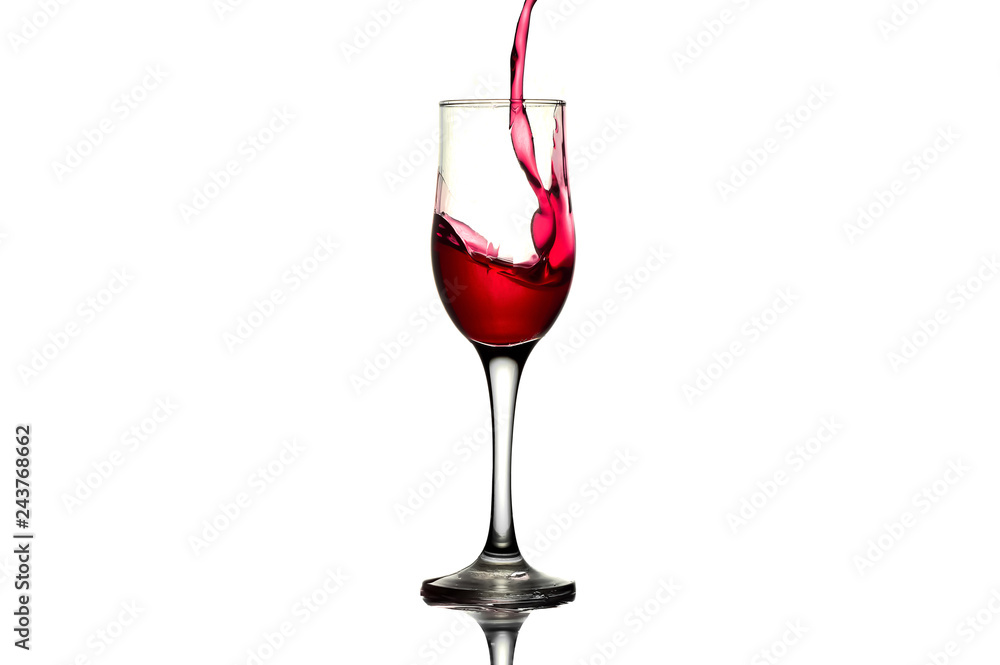 red wine pouring into wine glass isolated. Splash of red wine in a glass on a white background with reflection red wine pouring into wine glass isolated. Splash of red wine in a glass on a white background with reflection