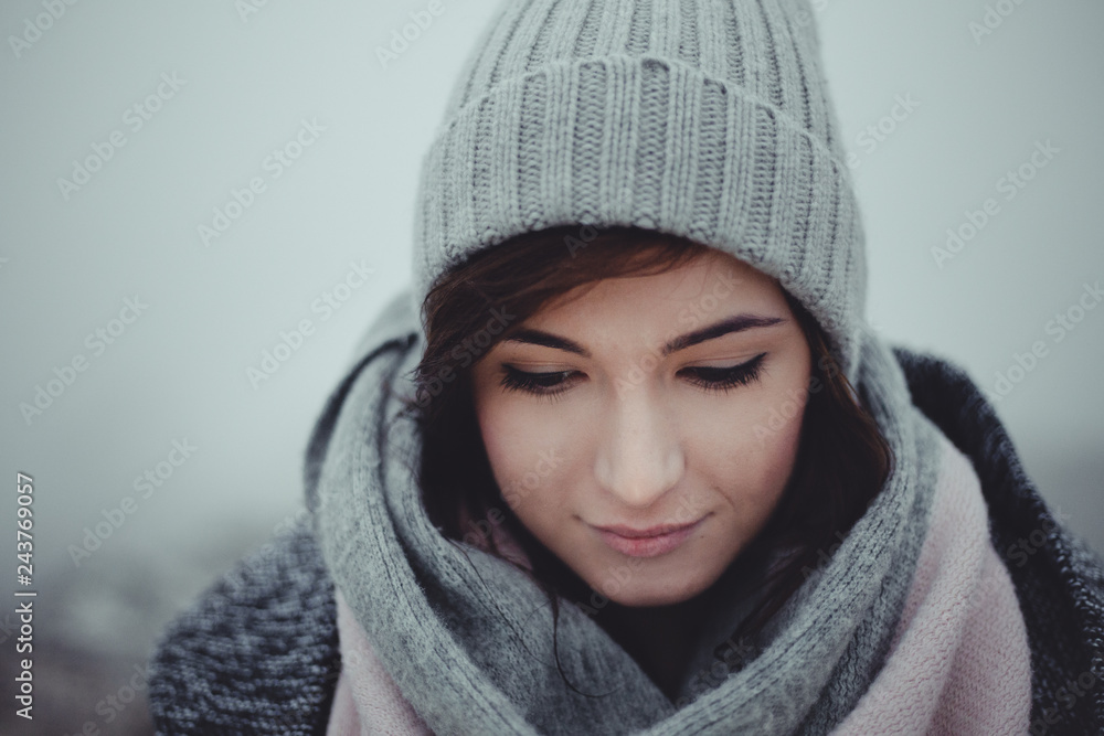 Close up portrait of woman who looking down on misty background. Photo of beautiful fashion model with a cap in winter time. Girl with closed eyes on foggy background. Winter portrait of girl Close up portrait of woman who looking down on misty background. Photo of beautiful fashion model with a cap in winter time. Girl with closed eyes on foggy background. Winter portrait of girl