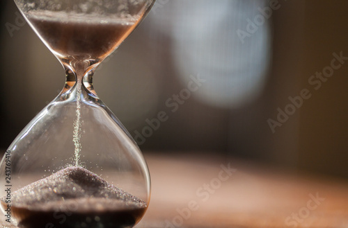 Hourglass as time passing concept for business deadline, urgency and running out of time. Sandglass, egg timer showing the last second or last minute or time out. With copy space.
