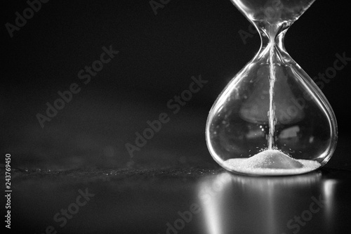 Hourglass as time passing concept for business deadline, urgency and running out of time. Sandglass, egg timer showing the last second or last minute or time out.  With copy space.