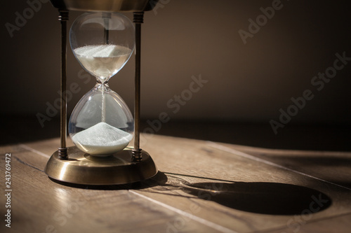 Hourglass as time passing concept for business deadline, urgency and running out of time. Sandglass, egg timer showing the last second or last minute or time out.  With copy space.
