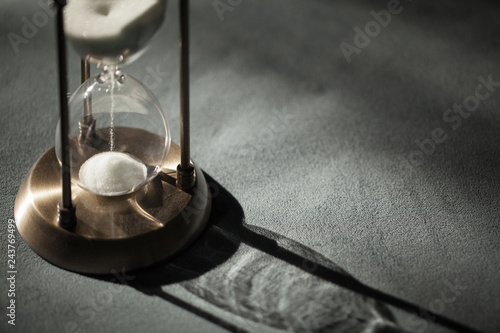 Hourglass as time passing concept for business deadline, urgency and running out of time. Sandglass, egg timer showing the last second or last minute or time out. With copy space.