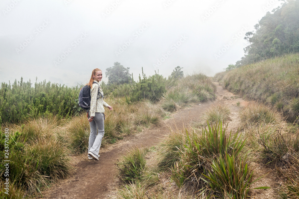 Girl walks in the Horton Plains National Park. Sri Lanka