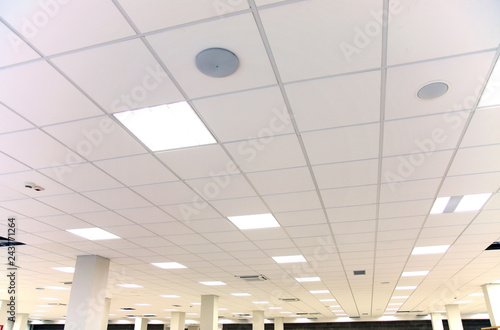 White office ceiling with white tiles and lighting