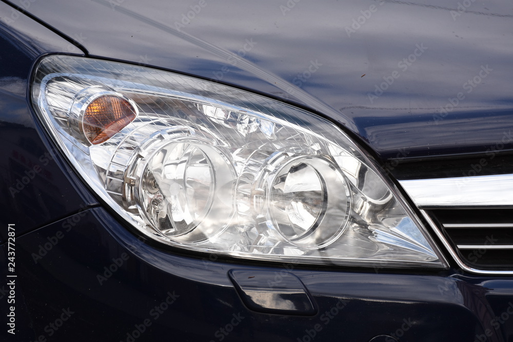 shiny headlights on a blue car