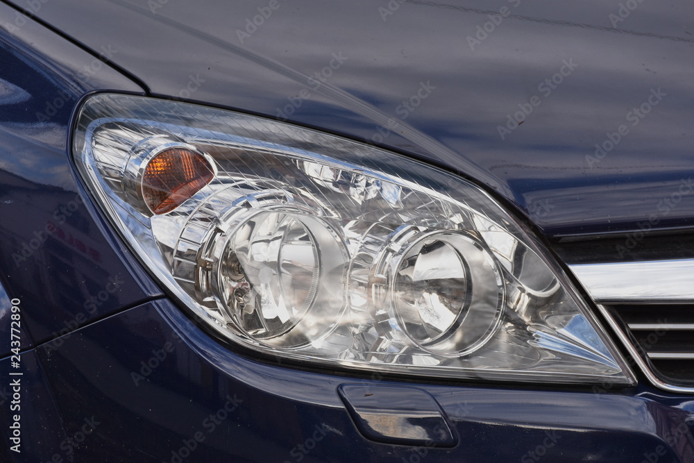 shiny headlights on a blue car