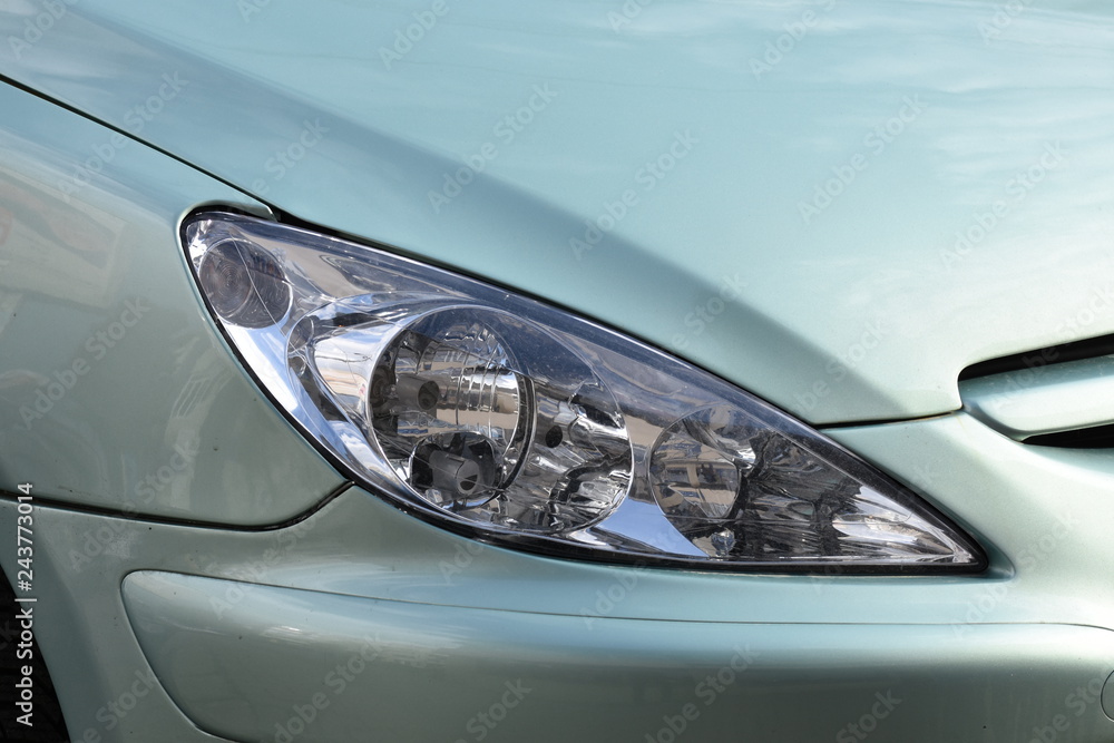 shiny headlights on a green  car