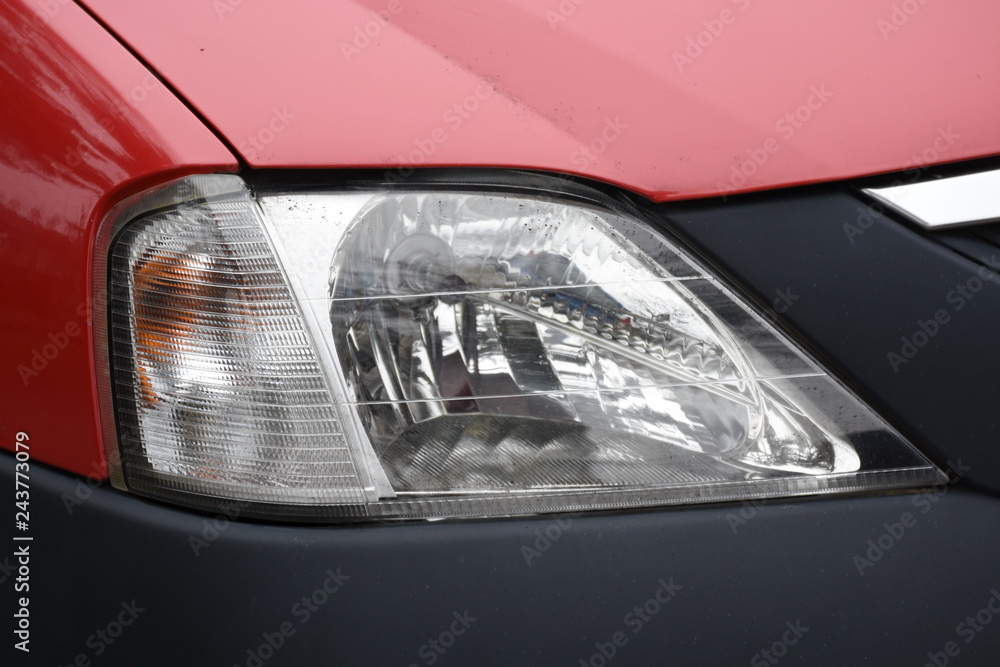 shiny headlights on a red car