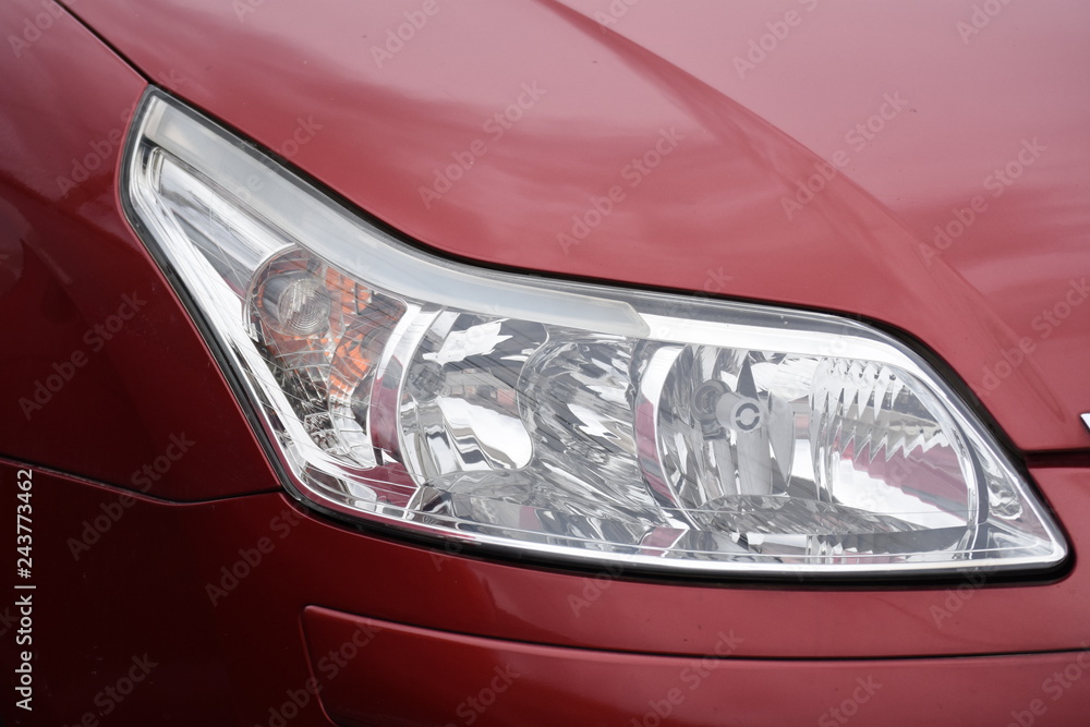 shiny headlights on a  red car