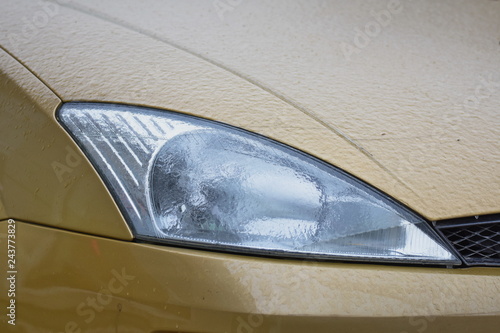  Frozen car headlight Freezing rain ice coated car. 