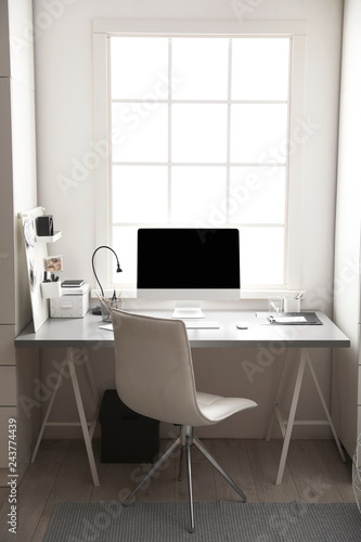 Light work place with computer near window. Interior design