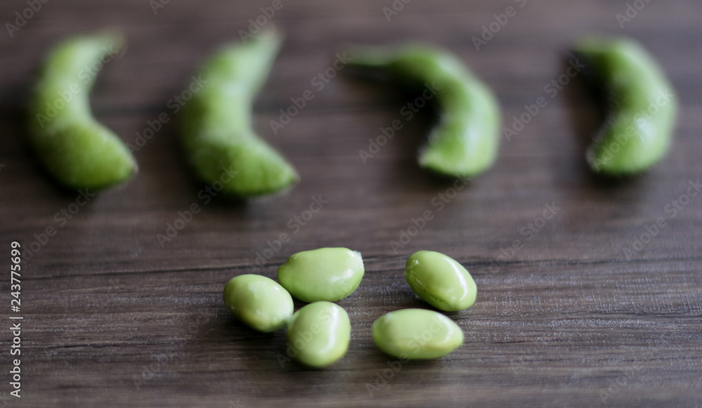 Young soy beans or edamame on wood background. Young soy beans or edamame on wood background.