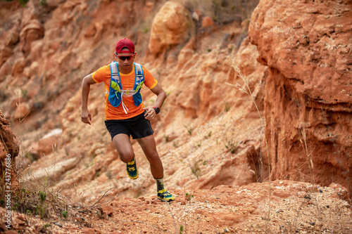 A man Runner of Trail . and athlete's feet wearing sports shoes for trail running in the mountains