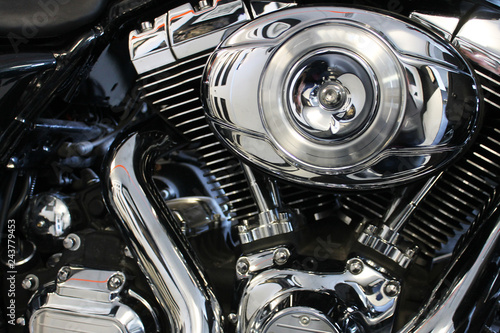 Close-up of motorcycle engine, lots of chrome. © Stephen