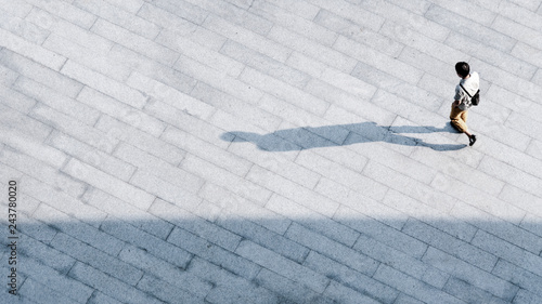 Cuadro en lienzo top aerial view people walk on across pedestrian concrete with black silhouette shadow on ground, concept of social still life