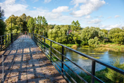 Pedestrian bridge over the river Protva in the town of Borovsk, Russia. Clear summer day   © PhotoChur