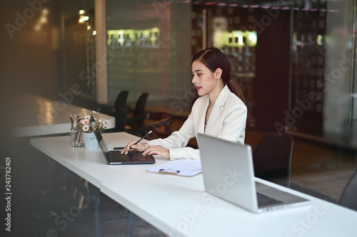 Business woman working with laptop computer on office workplace.