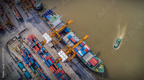 Logistics and transportation of Container Cargo ship and Cargo plane with working crane bridge in shipyard at sunrise, logistic import export and transport industry background