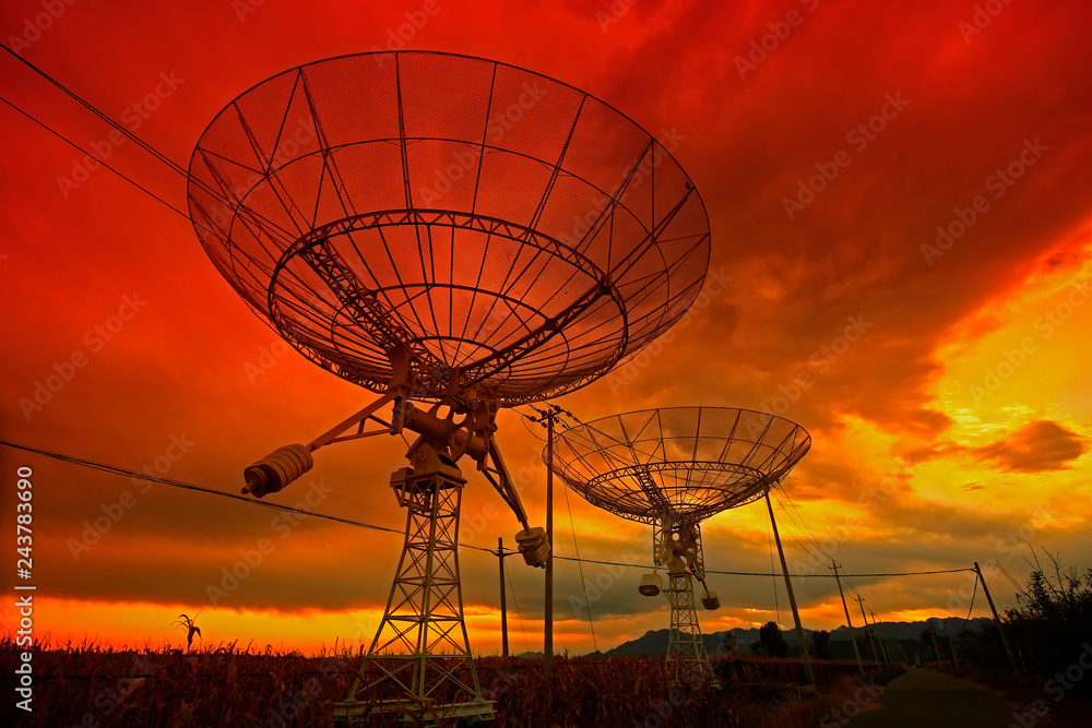 The silhouette of a radio telescope observatory