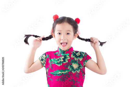 Little asian girl in traditional chinese costume smiling over white background