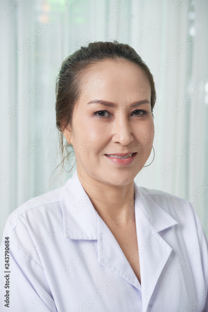 Portrait of smiling Asian female doctor in white labcoat Portrait of smiling Asian female doctor in white labcoat