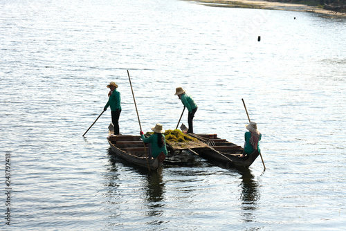 Siem Reap,Cambodia-Januay 11, 2019: People remove waterweed from the moat surrounding Angkor Thom, Siem Reap, Cambodia