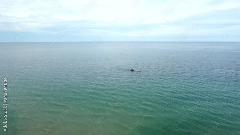 Aerial view of small fishing boat navigating on calm water, Ko Chang, Thailand. Aerial view of small fishing boat navigating on calm water, Ko Chang, Thailand.