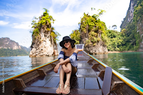 A beautiful asian woman traveling by long tail boat.