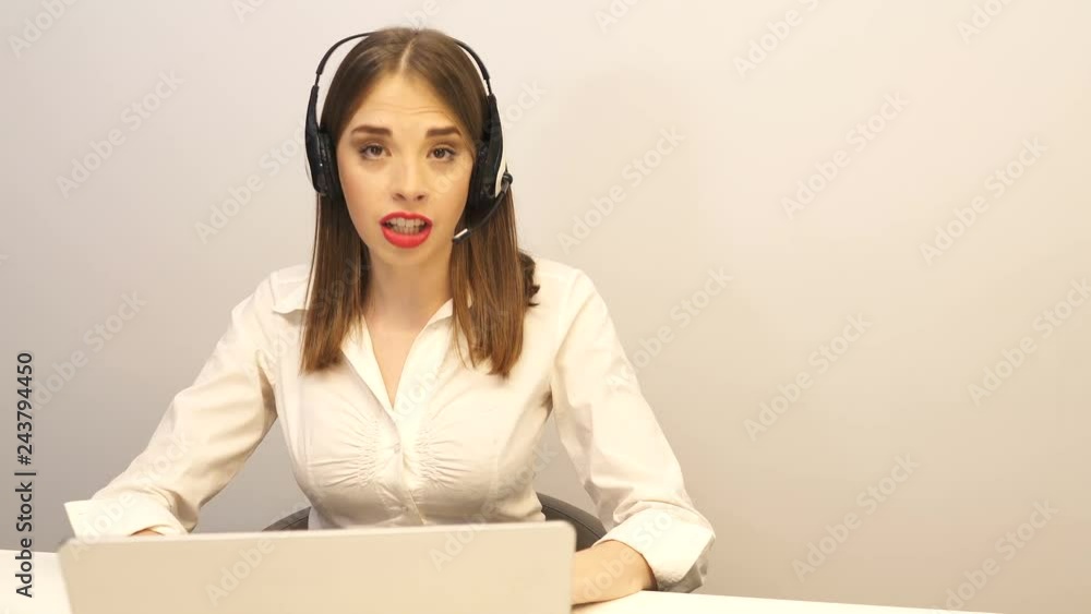 4K. Sexy woman operator in customer support service center answer call, looking at camera. Dolly shot 4K. Sexy woman operator in customer support service center answer call, looking at camera. Dolly shot