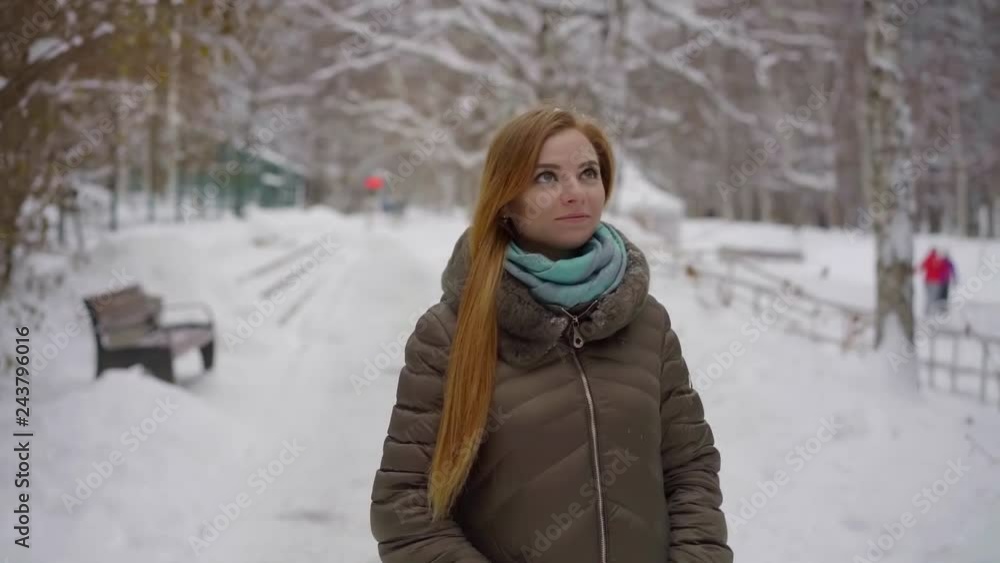 portrait of a long-haired, beautiful, thoughtful girl who walks through the snowy Park in winter and smiles. portrait of a long-haired, beautiful, thoughtful girl who walks through the snowy Park in winter and smiles.