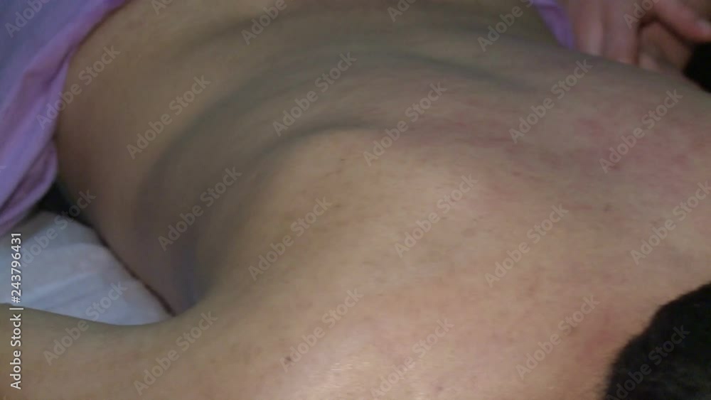 Two massage therapists give a massage to a man and a woman in special massage rooms Two massage therapists give a massage to a man and a woman in special massage rooms