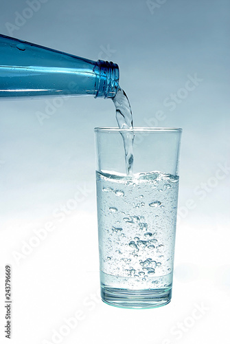 Mineral water in a bottle and in a glass