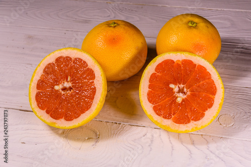 Ripe juicy grapefruit on a white wooden table