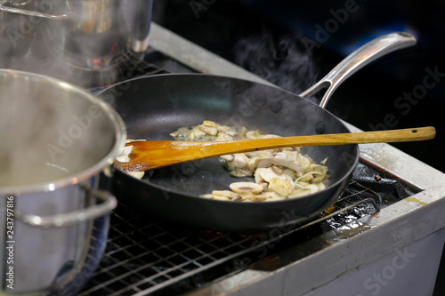 Working chef preparing food, Food frying in wok pan. Close up. chef cooking