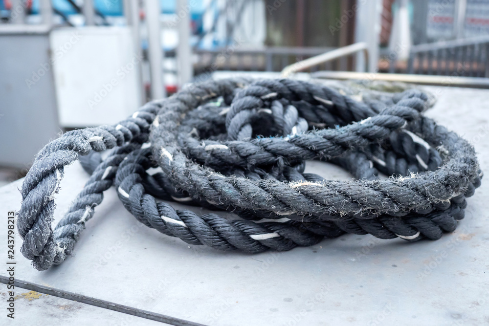 An old, used rope somewhere on a boat at the harbor